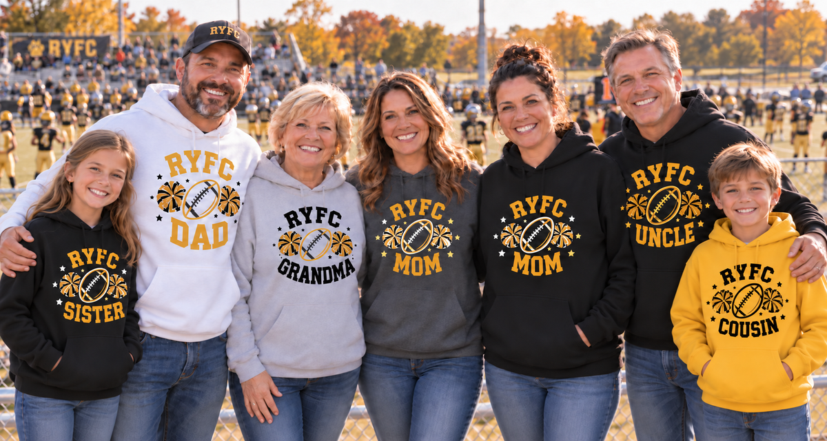A family of seven stands together on a football field wearing matching custom 'RYFC' hoodies and t-shirts in black, gray, white, and yellow. The shirts feature a football graphic and the text 'RYFC' with different family names like 'Dad', 'Grandma', 'Mom', 'Uncle', 'Sister', and 'Cousin'.